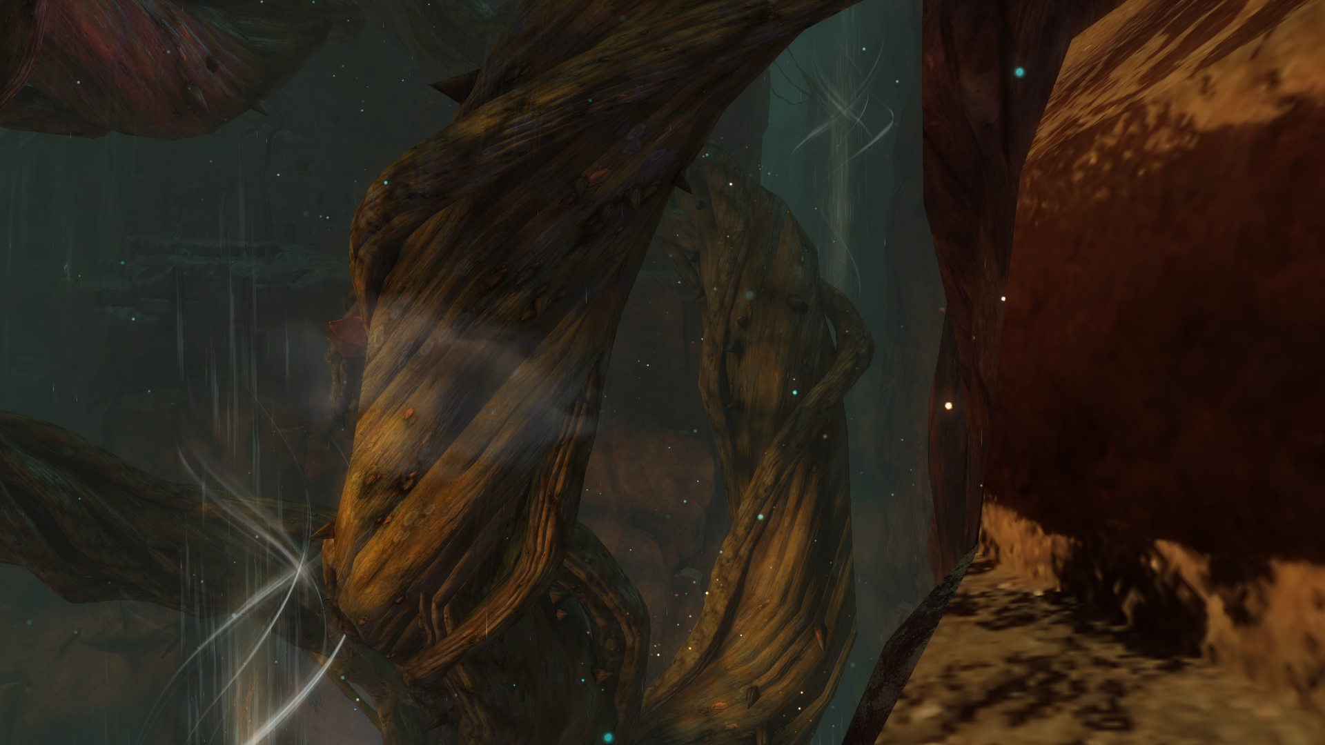 Sandstone cliffs and towering jungle plant frame a deep crevasse